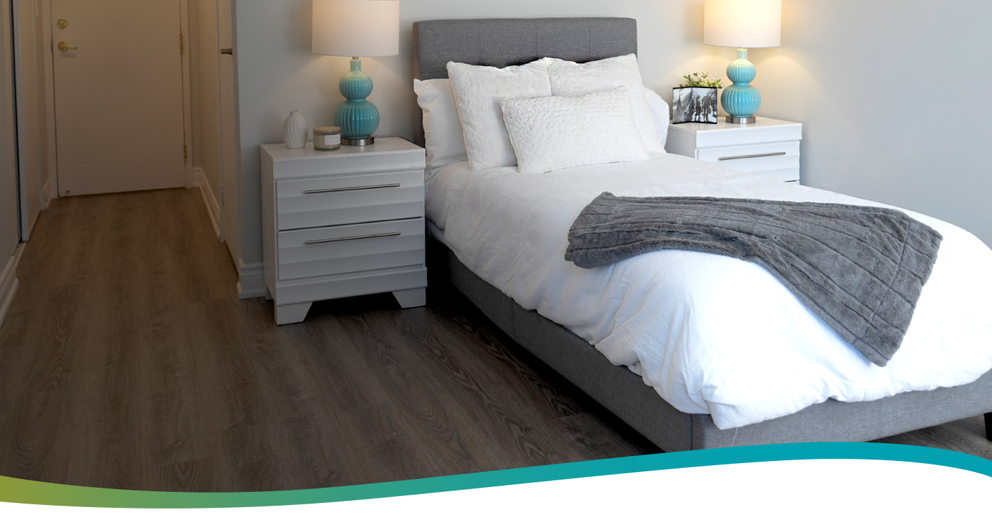 Bed and nightstands in a model suite at Atrium Retirement Residence in Orillia.